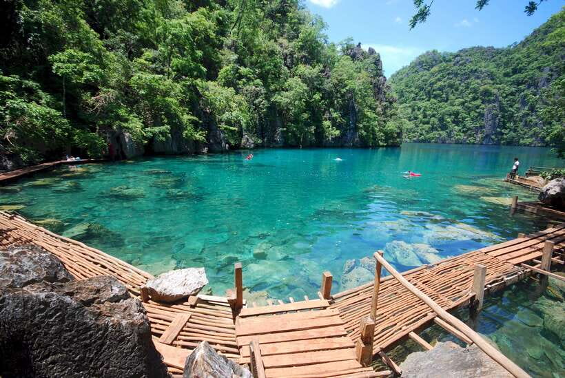 From Coron: Twin Lagoon and Skeleton Wreck Cruise with Lunch - Malcapuya Island: panoramic cliffs before the swimming starts